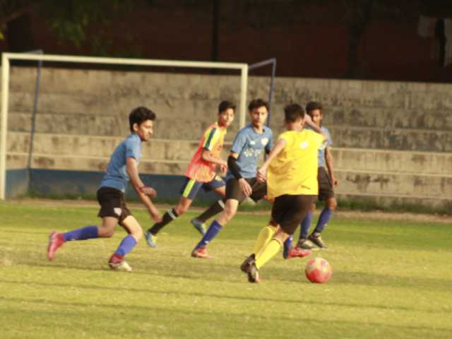 boys playing football